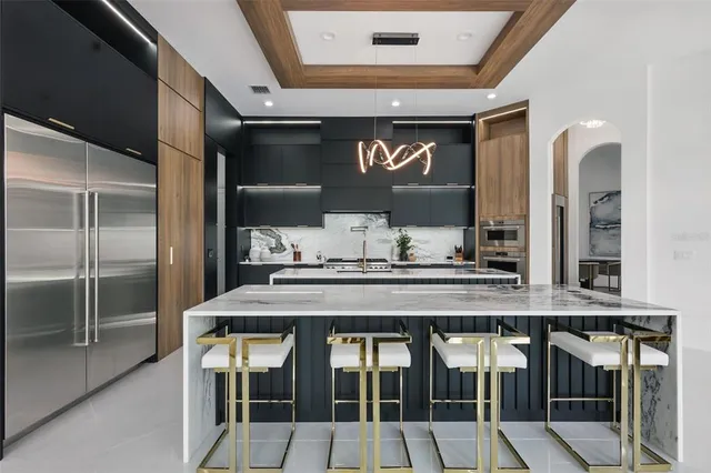 a kitchen with stainless steel appliances granite countertop a sink stove and cabinets