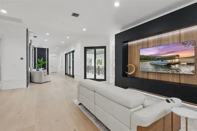 a spacious bedroom with a bed and a painting on the wall