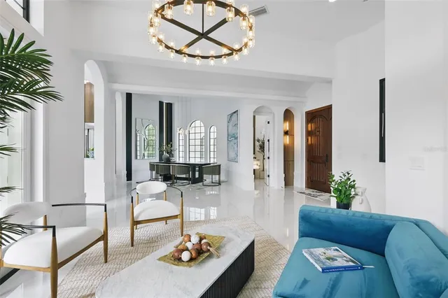 a living room with furniture a fireplace and a large window