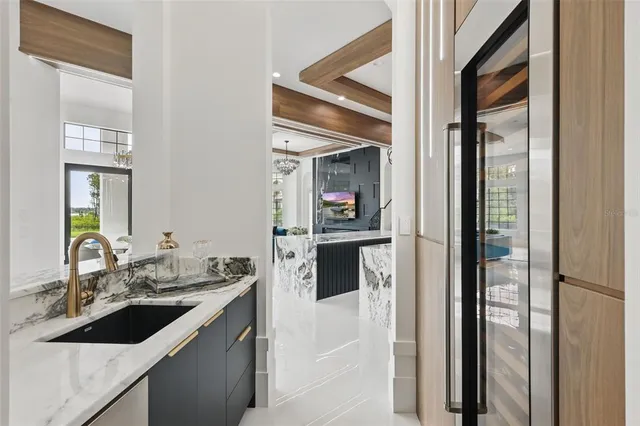 a kitchen with stainless steel appliances kitchen island granite countertop a table and chairs in it
