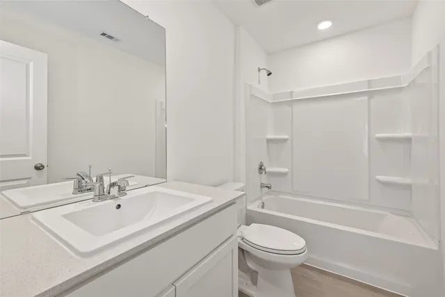 a bathroom with a sink a toilet and a bathtub