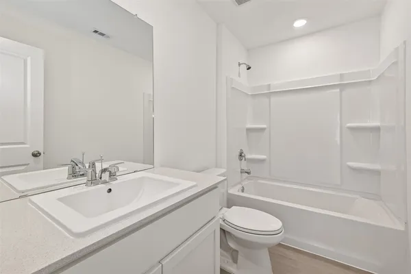 a bathroom with a sink a toilet and a bathtub