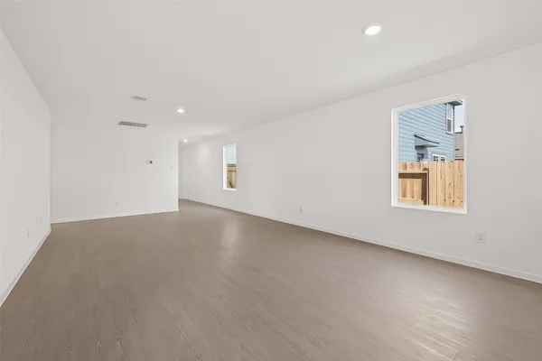 an empty room with a empty space and windows