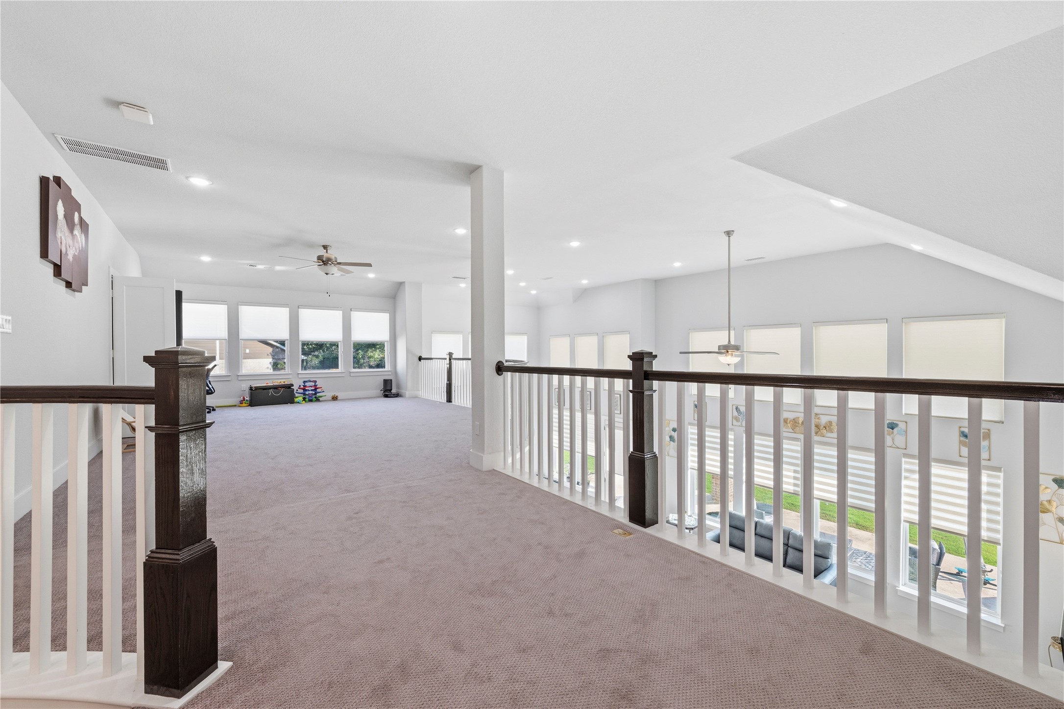 105 Autumn Oak Way Georgetown, TX 78628 - Photo 29 of 40 Carpeted loft space featuring white balustrade railings with dark wood newel posts and handrails