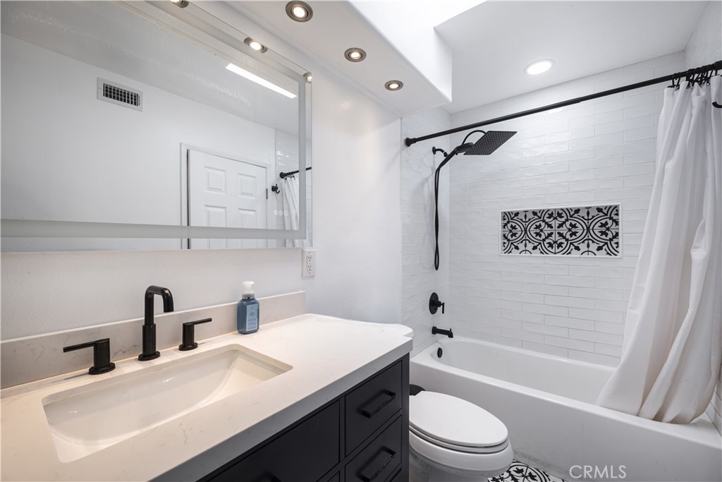 2203 Homewood Avenue Simi Valley, CA 93063 - Photo 26 of 37 a bathroom with a sink a toilet a mirror a vanity and shower