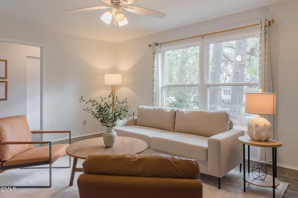 a view of a dining room with furniture and a potted plant