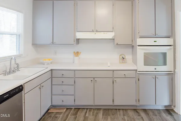 a kitchen with sink cabinets and window