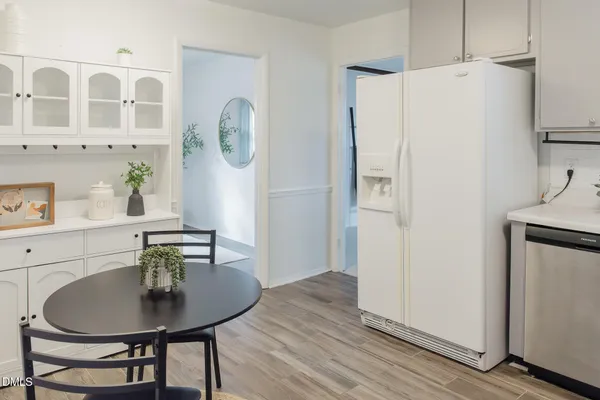 a kitchen with a sink cabinets and wooden floor