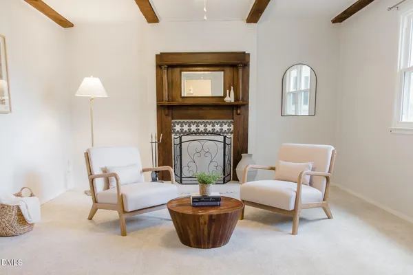 a kitchen with stainless steel appliances a table and chairs