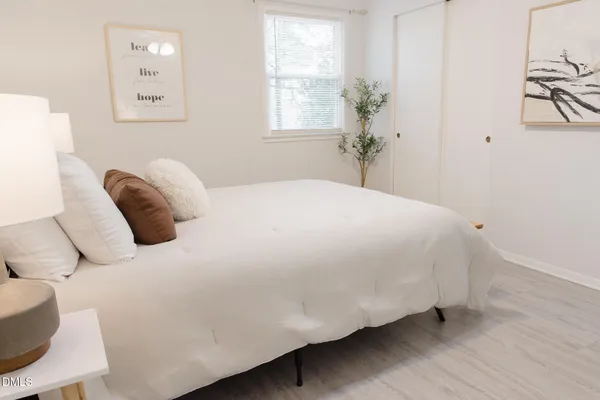 a bedroom with a bed and a window