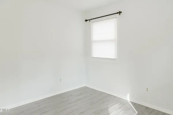 a bathroom with a toilet sink vanity and mirror