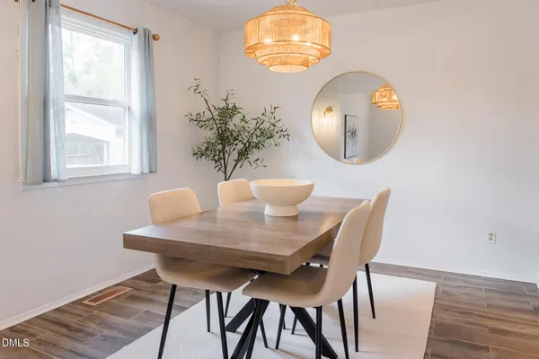 a view of a dining room with furniture and chandelier