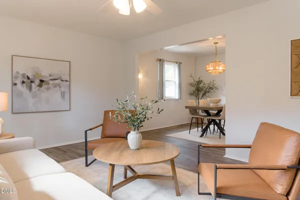 a view of a dining room with furniture and chandelier