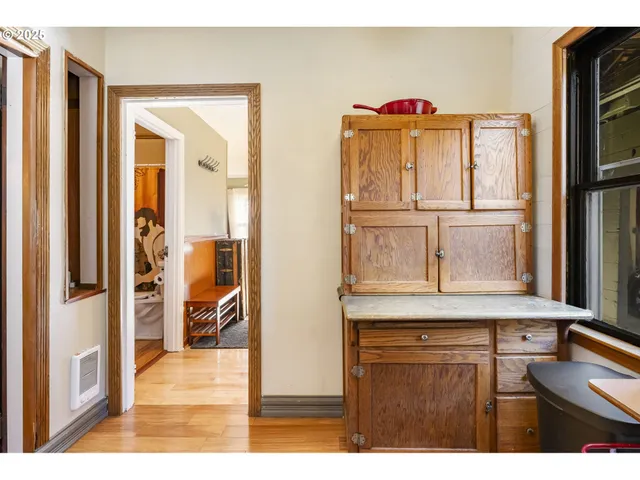 a kitchen with a refrigerator and cabinets