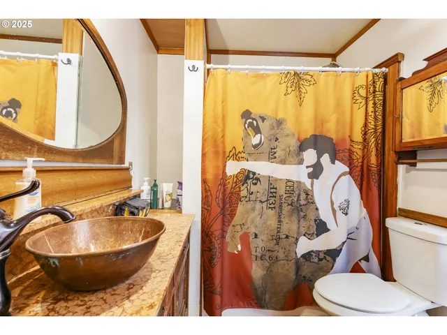 a bathroom with a sink and mirror with bathtub