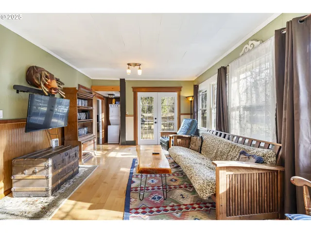 a living room with furniture large window and flat screen tv