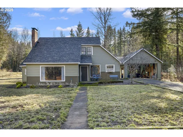 a front view of a house with a yard and trees