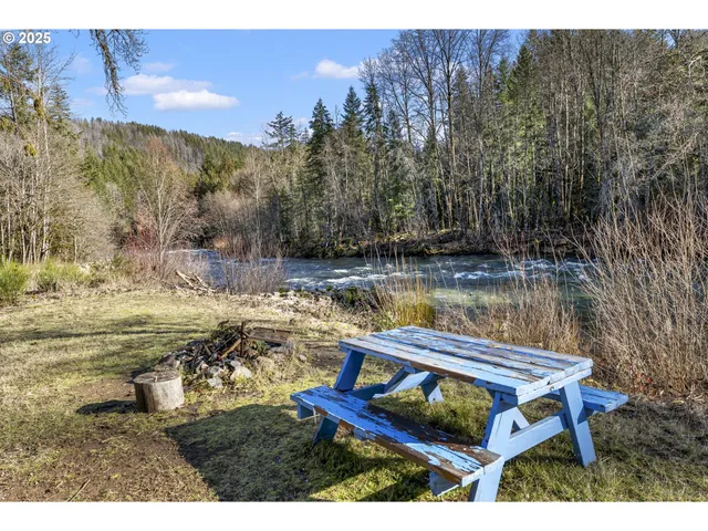 a backyard of a house with table and chairs