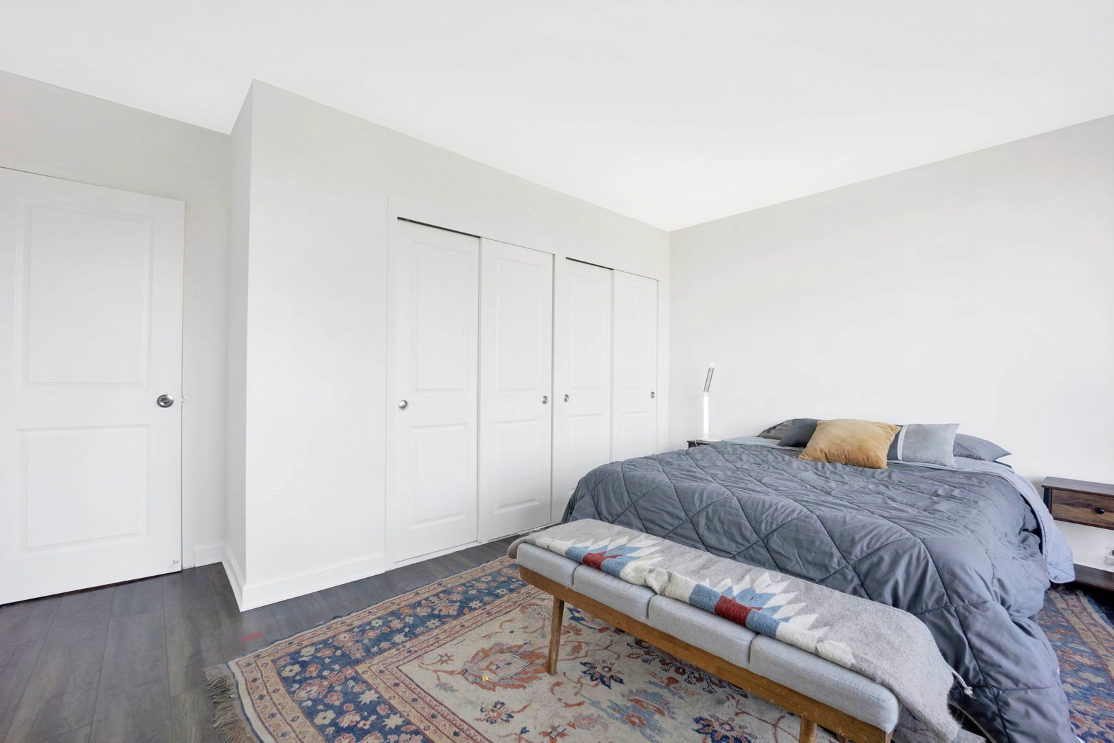 1550 North Lake Shore Drive, Unit 3C Chicago, IL 60610 - Photo 8 of 16 a living room with a bed and a wooden floor