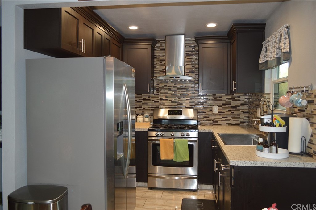 5577 Pioneer Boulevard, Unit 9 Whittier, CA 90601 - Photo 11 of 45 a kitchen with a sink a stove and refrigerator