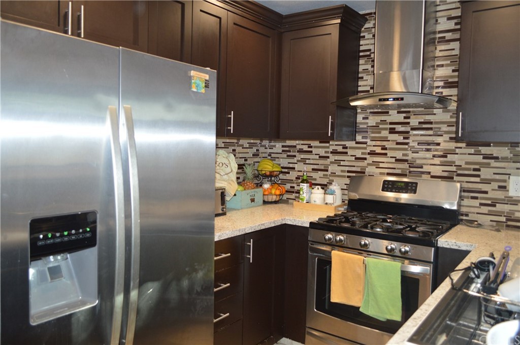 5577 Pioneer Boulevard, Unit 9 Whittier, CA 90601 - Photo 12 of 45 a kitchen with stainless steel appliances granite countertop a sink stove and refrigerator