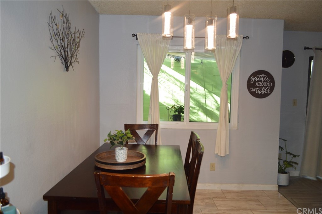 5577 Pioneer Boulevard, Unit 9 Whittier, CA 90601 - Photo 14 of 45 a view of a dining room with furniture window and outside view