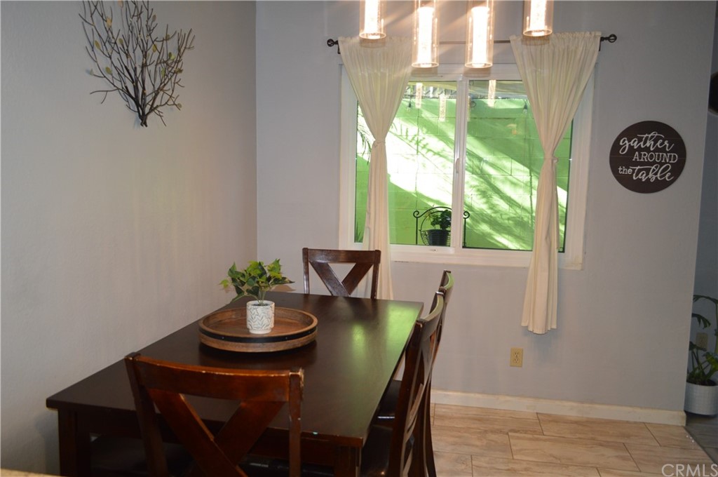 5577 Pioneer Boulevard, Unit 9 Whittier, CA 90601 - Photo 15 of 45 a view of a dining room with furniture window and outside view