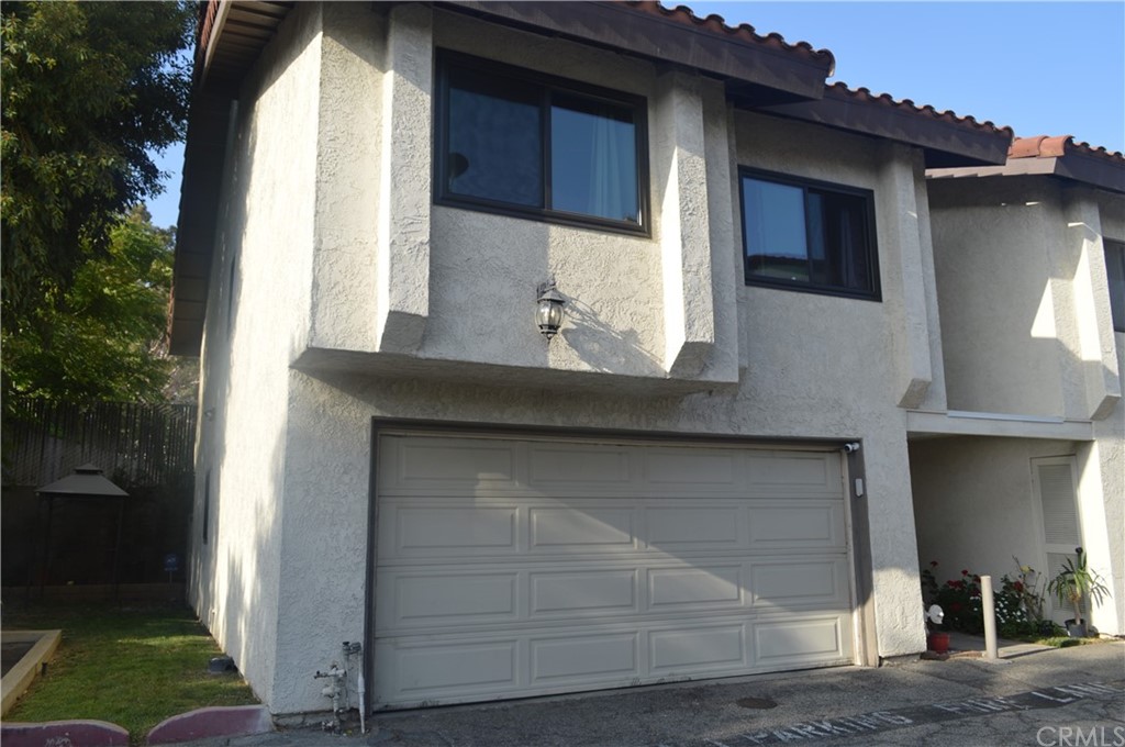 5577 Pioneer Boulevard, Unit 9 Whittier, CA 90601 - Photo 2 of 45 a front view of a house with garden