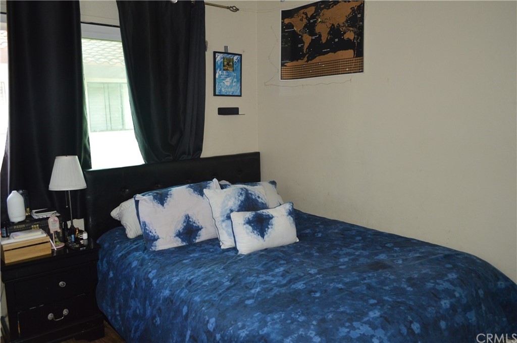 5577 Pioneer Boulevard, Unit 9 Whittier, CA 90601 - Photo 28 of 45 a bed sitting in a bedroom next to a window