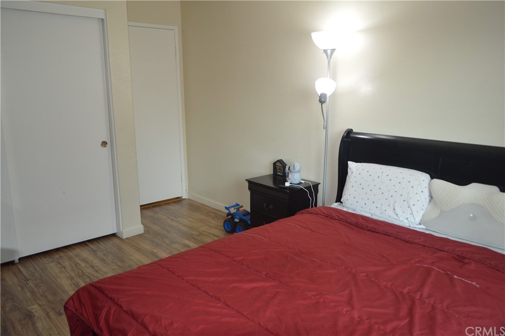 5577 Pioneer Boulevard, Unit 9 Whittier, CA 90601 - Photo 30 of 45 a bedroom with a bed and a night stand