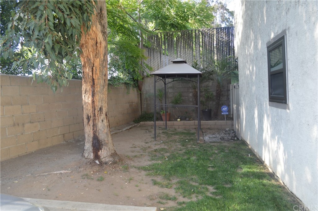 5577 Pioneer Boulevard, Unit 9 Whittier, CA 90601 - Photo 37 of 45 a backyard of a house with lots of green space