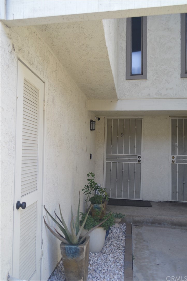 5577 Pioneer Boulevard, Unit 9 Whittier, CA 90601 - Photo 4 of 45 a potted plant sitting in front of a door