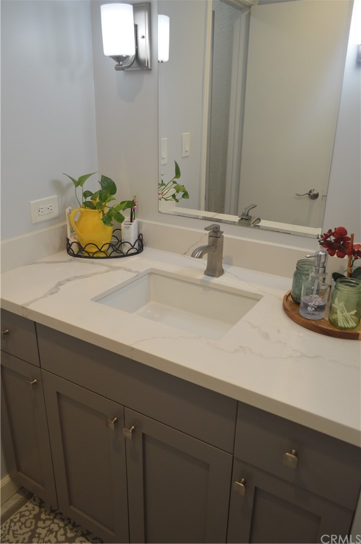 5577 Pioneer Boulevard, Unit 9 Whittier, CA 90601 - Photo 42 of 45 a bathroom with a sink and a mirror