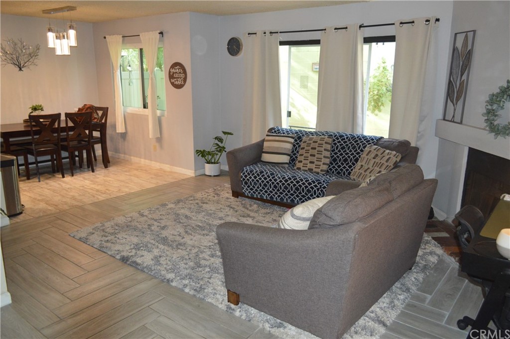 5577 Pioneer Boulevard, Unit 9 Whittier, CA 90601 - Photo 8 of 45 a living room with furniture and a flat screen tv