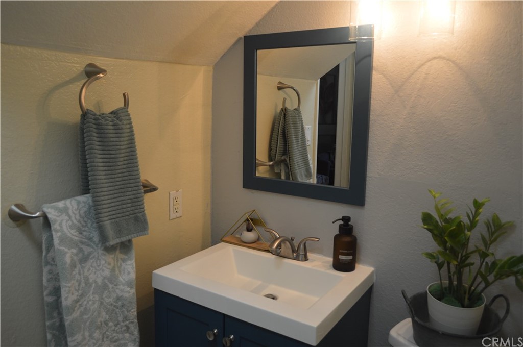 5577 Pioneer Boulevard, Unit 9 Whittier, CA 90601 - Photo 9 of 45 a bathroom with a sink and a mirror