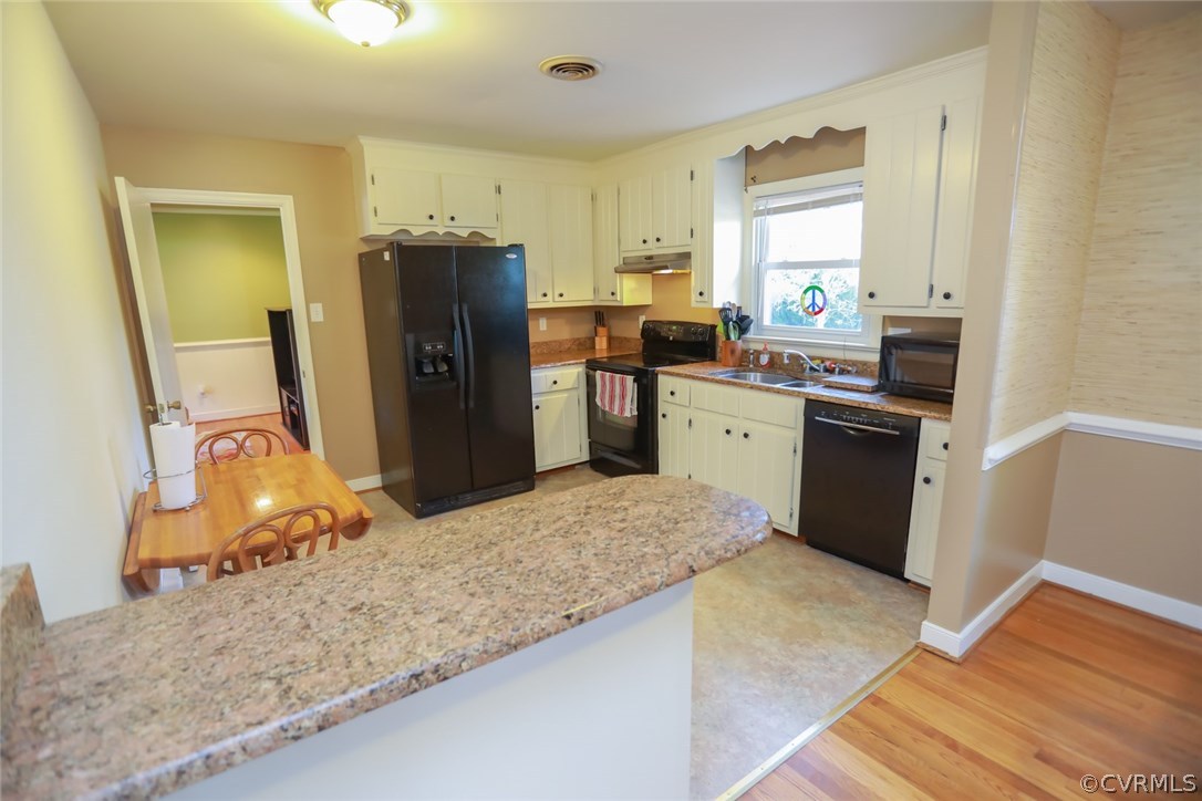 3350 Clintwood Road Midlothian, VA 23112 - Photo 4 of 18 a kitchen with a refrigerator sink and wooden cabinets
