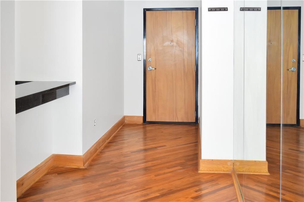 120 Ralph McGill Boulevard Northeast, Unit 402 Atlanta, GA 30308 - Photo 13 of 38 a view of a hallway with wooden floor