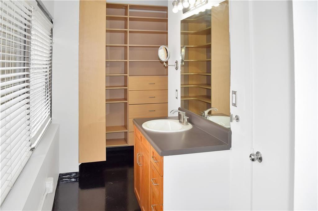 120 Ralph McGill Boulevard Northeast, Unit 402 Atlanta, GA 30308 - Photo 21 of 38 a bathroom with a sink and a mirror