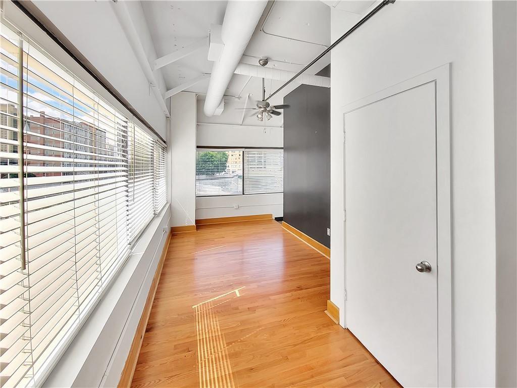 120 Ralph McGill Boulevard Northeast, Unit 402 Atlanta, GA 30308 - Photo 6 of 38 a view of hallway with wooden floor