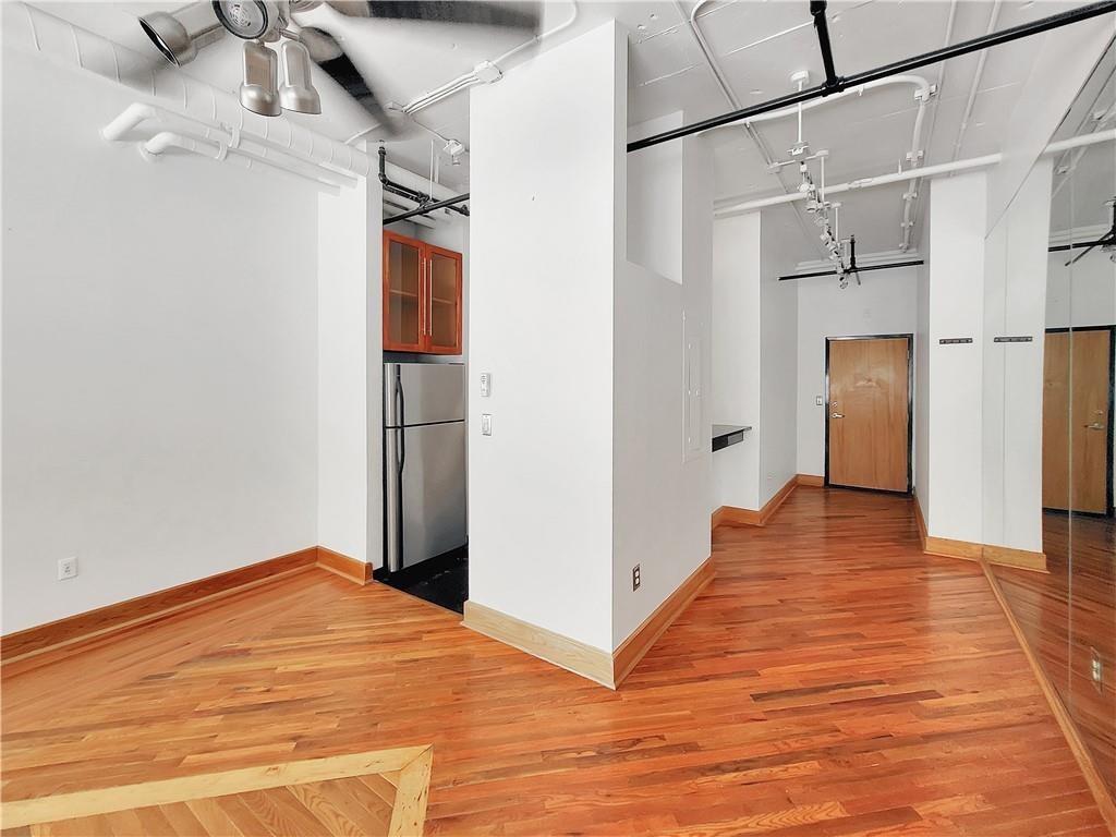 120 Ralph McGill Boulevard Northeast, Unit 402 Atlanta, GA 30308 - Photo 7 of 38 a view of a room with wooden floor