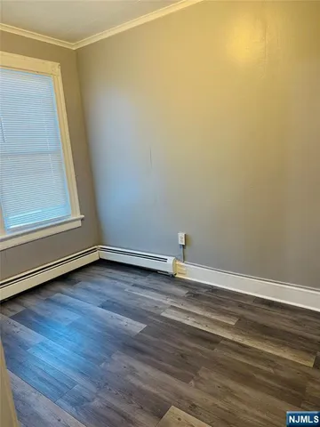 a view of a room with wooden floor and entrance