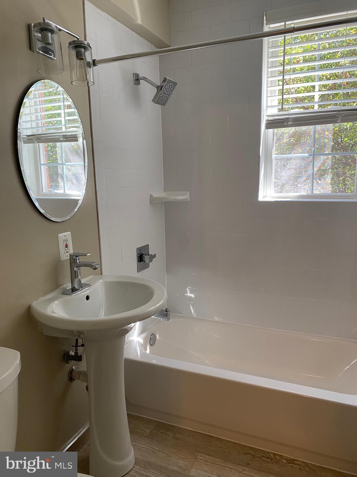 1805 Key Boulevard, Unit 511 Arlington, VA 22201 - Photo 16 of 26 a bathroom with a sink a mirror and a bathtub