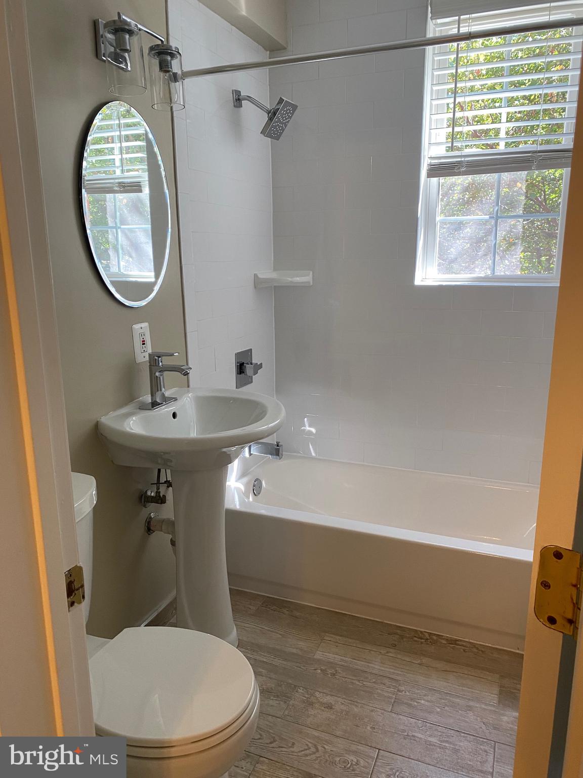 1805 Key Boulevard, Unit 511 Arlington, VA 22201 - Photo 17 of 26 a bathroom with a sink a mirror toilet and bathtub