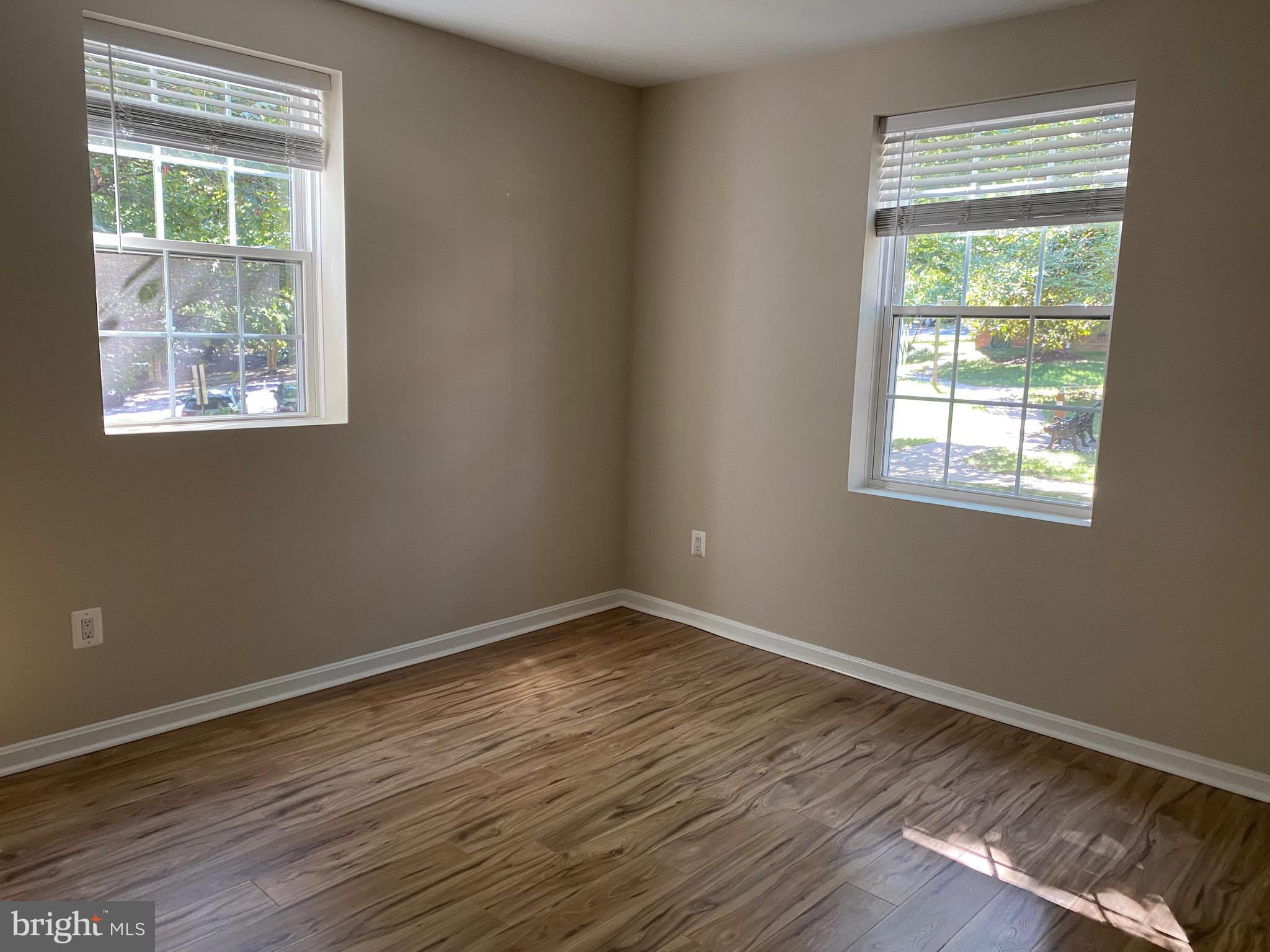 1805 Key Boulevard, Unit 511 Arlington, VA 22201 - Photo 21 of 26 an empty room with wooden floor and a window