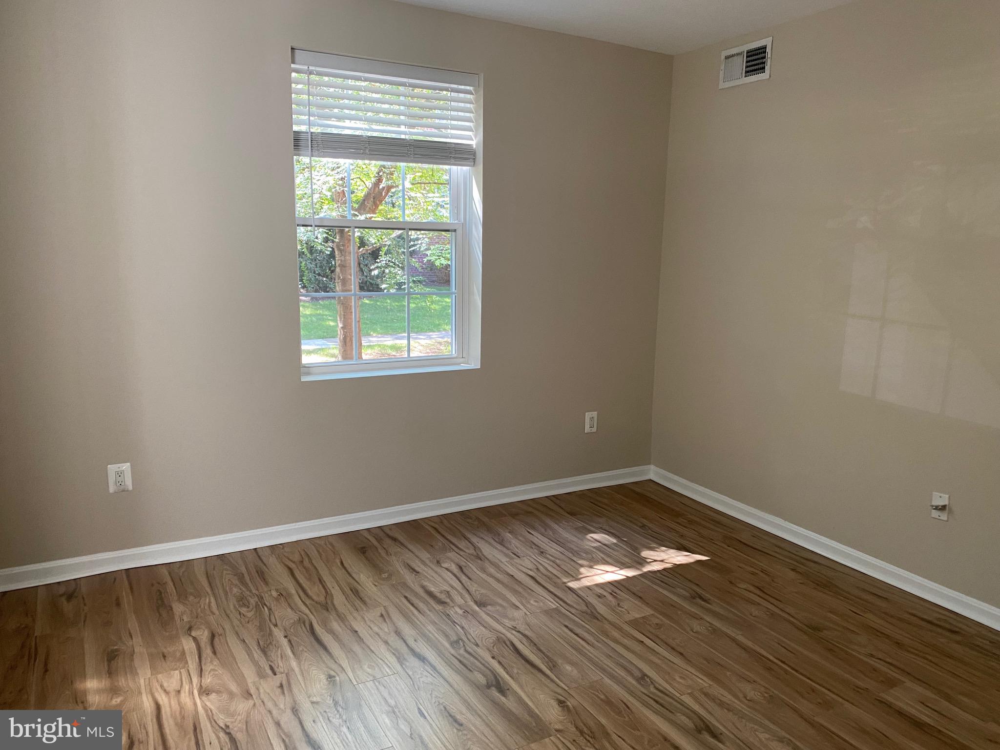 1805 Key Boulevard, Unit 511 Arlington, VA 22201 - Photo 23 of 26 a view of empty room with wooden floor and fan