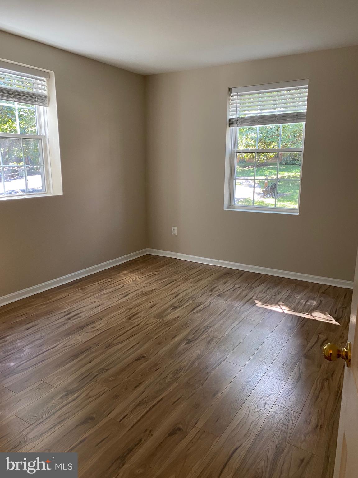 1805 Key Boulevard, Unit 511 Arlington, VA 22201 - Photo 25 of 26 a view of an empty room with wooden floor and a window