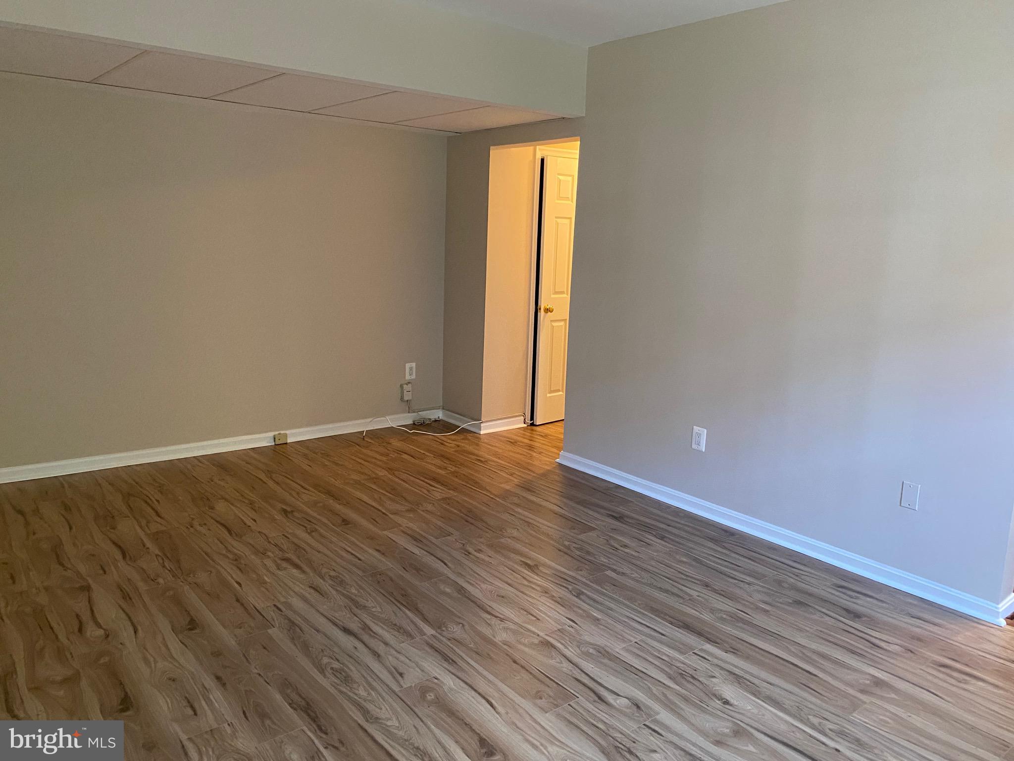 1805 Key Boulevard, Unit 511 Arlington, VA 22201 - Photo 5 of 26 a view of an empty room with wooden floor and a window