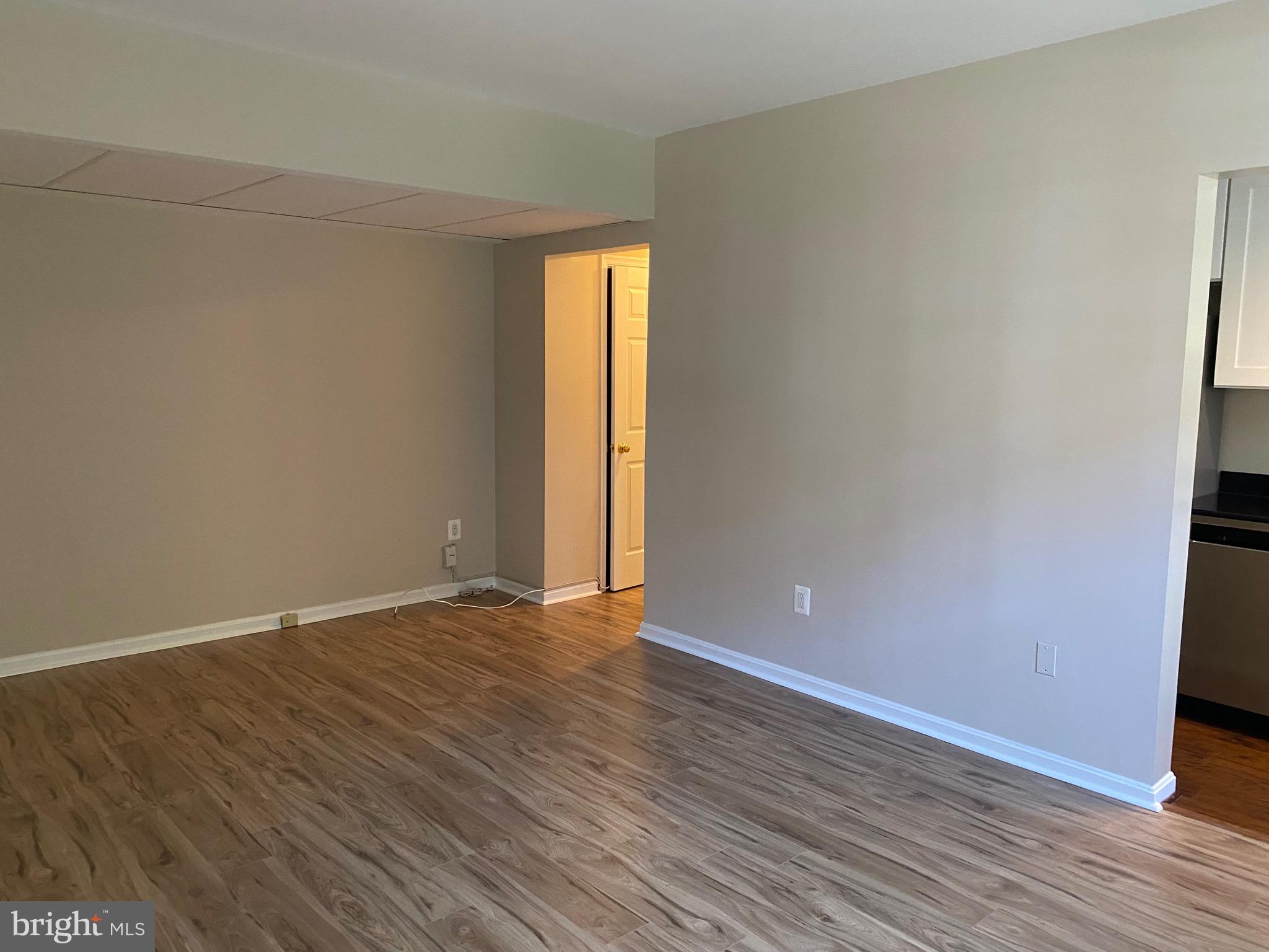 1805 Key Boulevard, Unit 511 Arlington, VA 22201 - Photo 6 of 26 a view of an empty room with wooden floor and a window