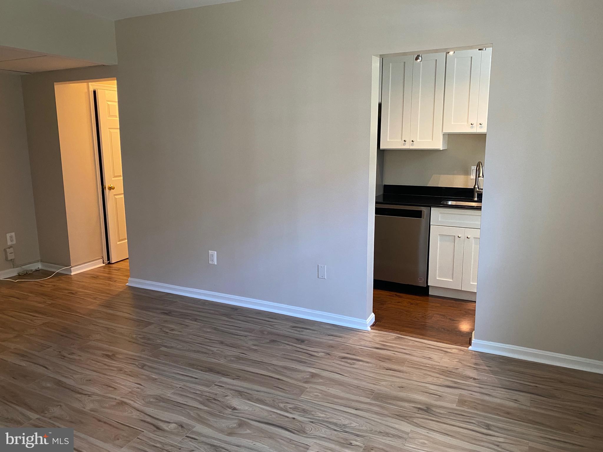 1805 Key Boulevard, Unit 511 Arlington, VA 22201 - Photo 7 of 26 a view of a kitchen with wooden floor and a sink
