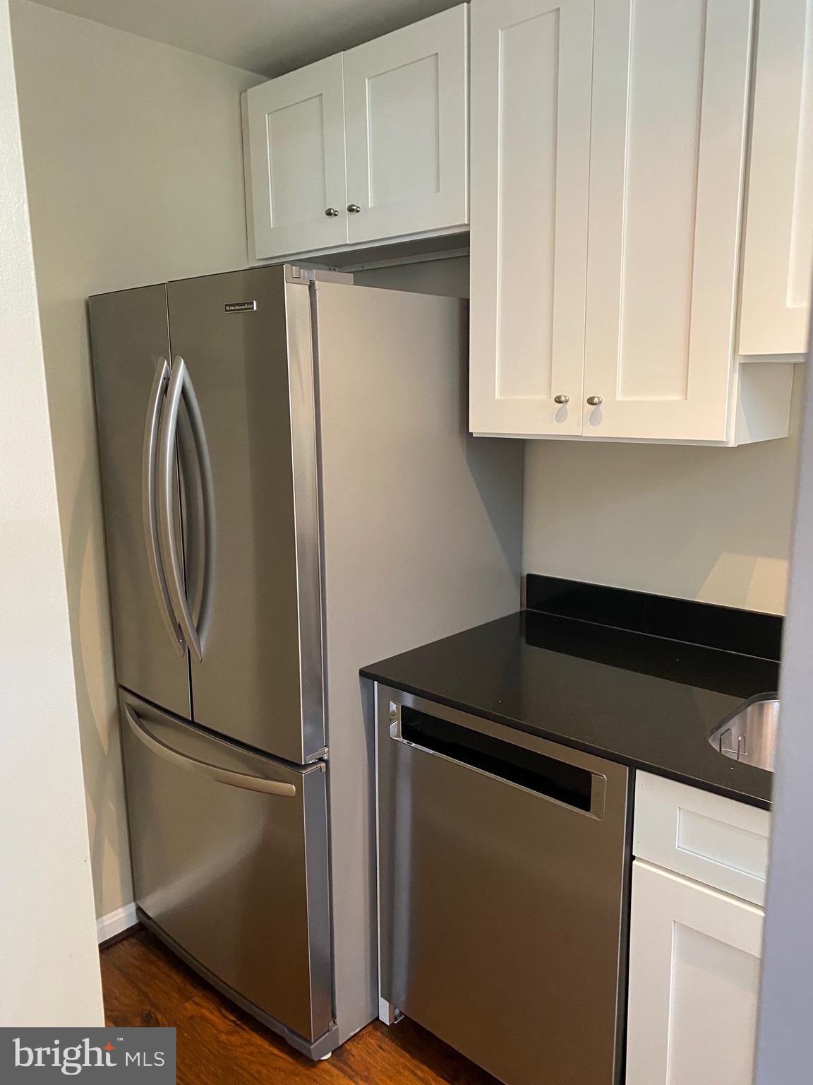 1805 Key Boulevard, Unit 511 Arlington, VA 22201 - Photo 10 of 26 a kitchen with cabinets and a refrigerator